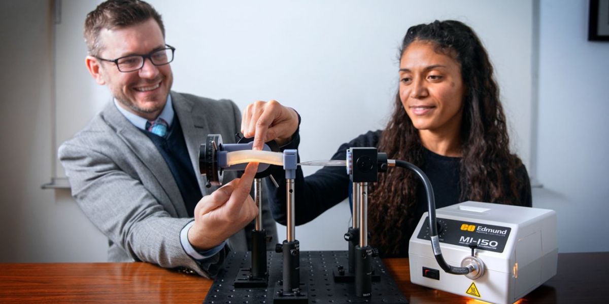 Associate professor Rob Shepherd and doctoral student Ilse van Meerbeek touch the elastomer foam containing optical fibers, a potential soft-robot technology that could be used along with machine learning to give a robot the ability to sense its orientation relative to its environment.