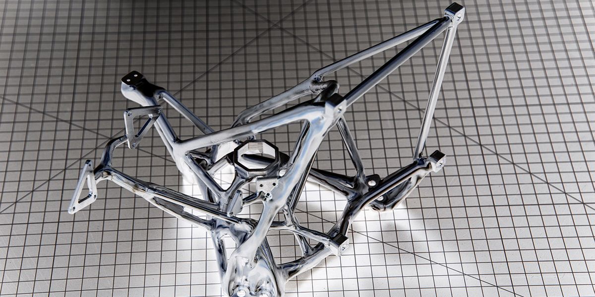Defined by a human designer, and filled in by an artificial intelligence program, this scaffold was milled from a solid block of aluminum and features connections for mirrors and instruments as well as pathways preserved for laser light and human hands to attach and adjust sensors. Credit: Henry Dennis
