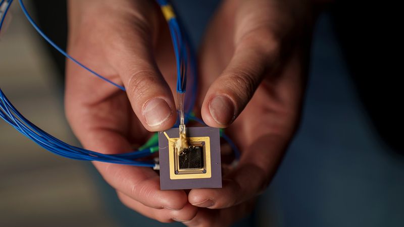 Corsetti’s work focuses on integrated photonics and involves building computer chips that route light instead of electricity, for applications like chip-sized 3D printers and trapped-ion quantum computers. Credit: Jodi Hilton
