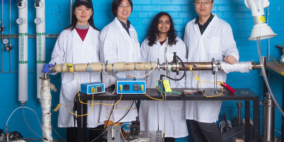 Left to right: Graduate student Chuwei Zhang, Assistant Professor Sili Deng, graduate student Maanasa Bhat, and postdoc Jianan Zhang stand behind the lab-scale apparatus they use to investigate a low-cost method of synthesizing materials critical for manufacturing lithium-ion batteries. Photo: Gretchen Ertl