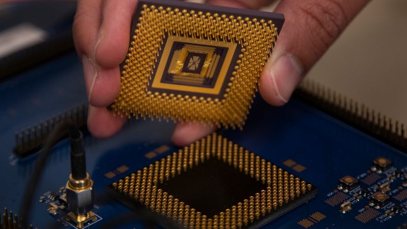The memristor array chip plugs into the custom computer chip, forming the first programmable memristor computer. The team demonstrated that it could run three standard types of machine learning algorithms. Photo: Robert Coelius, Michigan Engineering Communications & Marketing