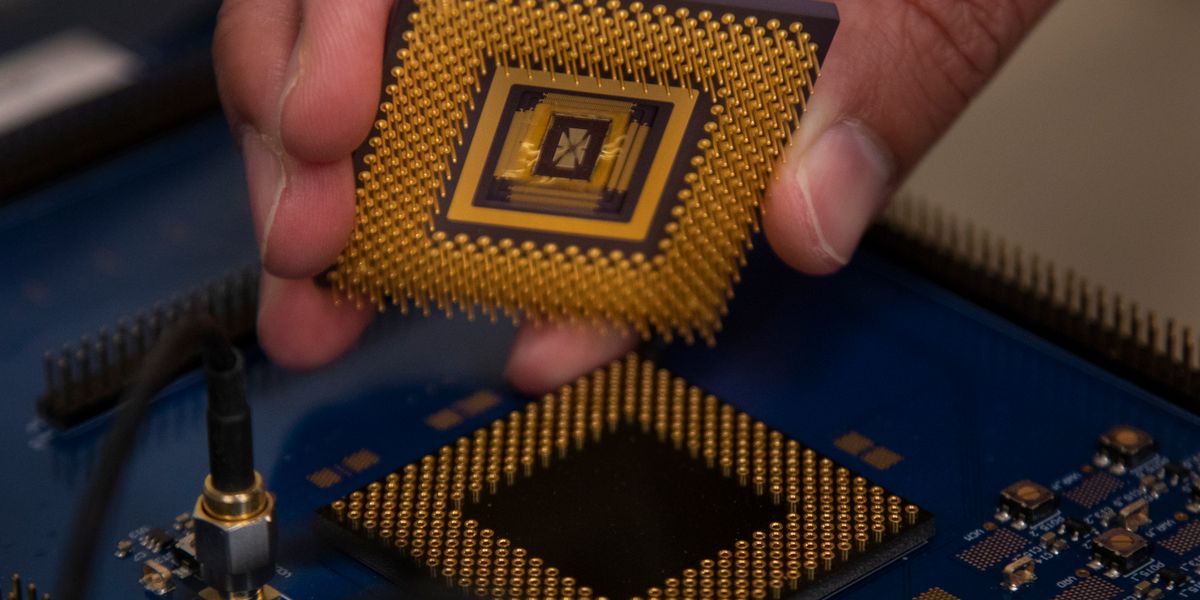 The memristor array chip plugs into the custom computer chip, forming the first programmable memristor computer. The team demonstrated that it could run three standard types of machine learning algorithms. Photo: Robert Coelius, Michigan Engineering Communications & Marketing