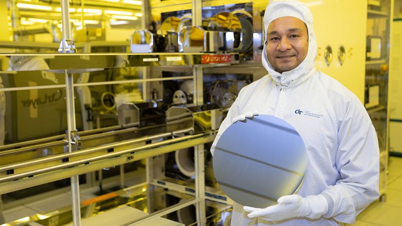 Asif Khan holds a silicon wafer in Georgia Tech’s cleanroom facility. Khan is trying to build new kinds of computer memory using fundamentally different mechanisms to store data. (Photo: Candler Hobbs)
