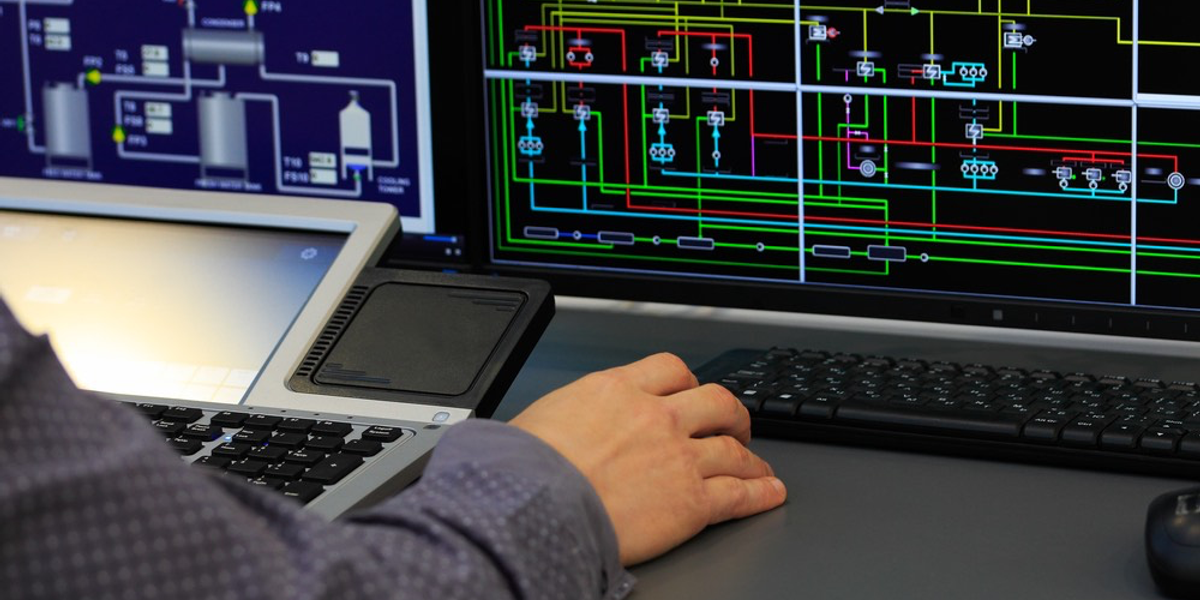 An engineer using SCADA to monitor and control industrial processes via PLC.