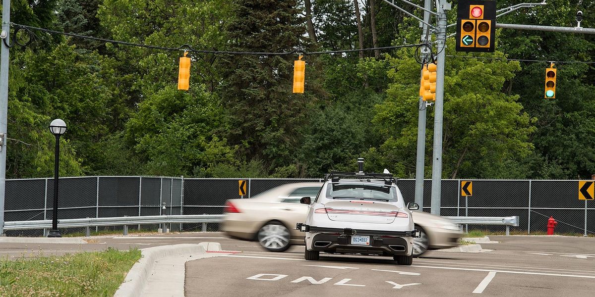 Even though it has the right of way, the connected and automated Lincoln MKZ stops at an intersection because another vehicle is running the light. Vehicle-to-vehicle communication enabled this safety feature. Photo by Michigan Photography