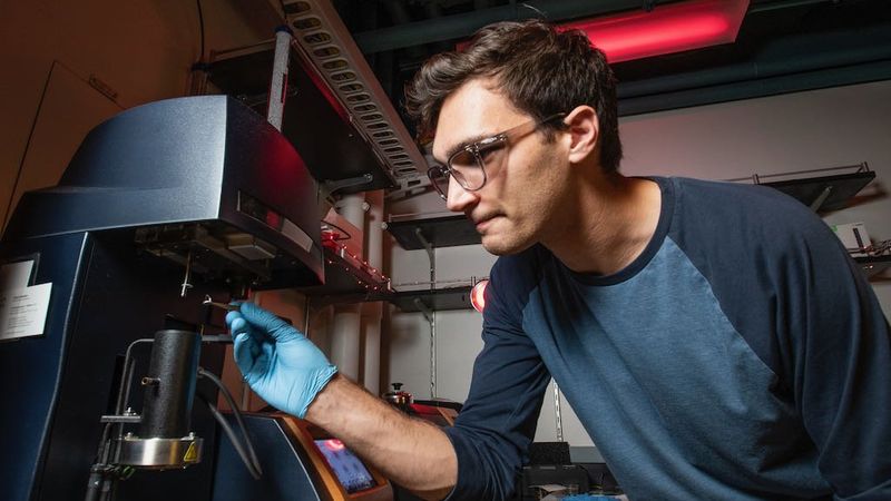 Max Saccone conducting thermogravimetric analysis experiments. Credit: Bob Paz