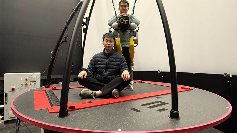 Yipu Chen (seated) and Zhaoyuan Gu (standing) on the CAREN treadmill system