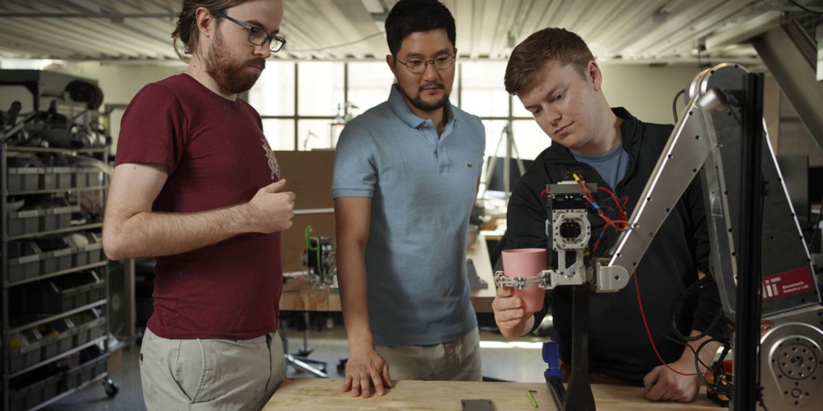 MIT researchers (from left): Elijah Stanger-Jones, Hongmin Kim, and Andrew SaLoutos have designed a robot gripper that incorporates reflexes to quickly grasp and sort everyday objects. Image: Jodi Hilton