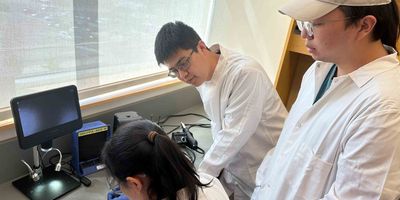 Assistant Professor of Biomedical Engineering Simiao Niu (center) works with graduate students Fuying Dong (left) and Chi Han (right) on a new "living bioelectronic" medical device they developed that combines advanced electronics, living cells and hydrogels. S. Niu