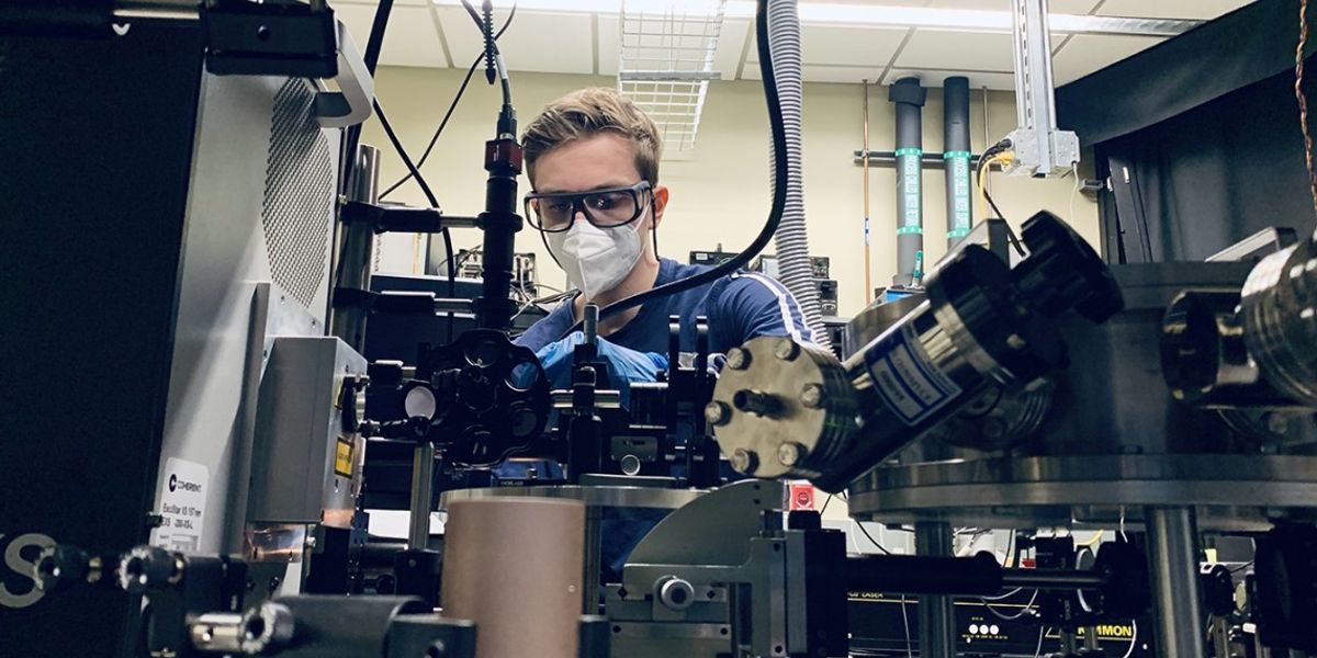 Doctoral student Len van Deurzen works with a lab setup used to operate a deep-ultraviolet laser-emitting device.