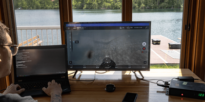 Operator using custom keyboard controls and laptop to pilot ROV.