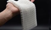 Material Inspired by Chain Mail Transforms from Flexible to Rigid on Command