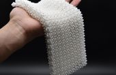 Material Inspired by Chain Mail Transforms from Flexible to Rigid on Command