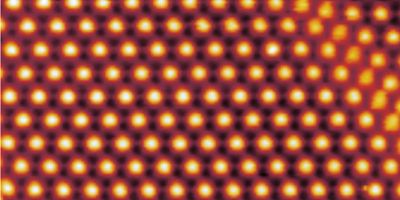 Image: The surface of a trilayer of graphene, as imaged by a scanning tunneling microscope. Due to the twist of a second layer, trilayer height is modulated with a period of about 9 nanometers.