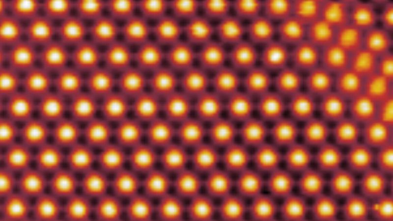 Image: The surface of a trilayer of graphene, as imaged by a scanning tunneling microscope. Due to the twist of a second layer, trilayer height is modulated with a period of about 9 nanometers.