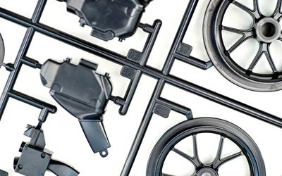 What are injection mold sprues, runners, and gates?