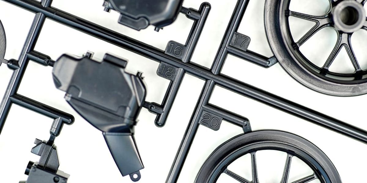 What are injection mold sprues, runners, and gates?