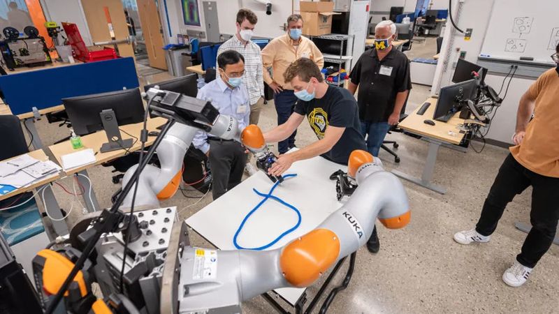 Peter Mitrano demonstrates a rope manipulation experiment. Software that he and Berenson developed can expand training data sets for challenges like rope manipulation, doubling the success rate of the robot. Credit: Daryl Marshke, Michigan Creative, University of Michigan. 