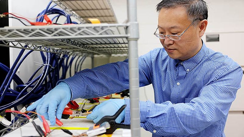 Wei Lu, a U-M professor of mechanical engineering cycling batteries in the Lu Lab. Photo: Brenda Ahearn