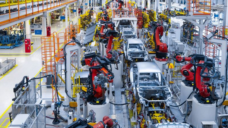 Assembly line production of new car. Automated welding of car body on production line. robotic arm on car production line is working