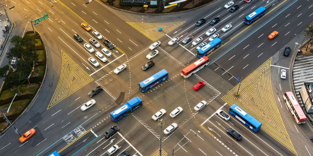 In a new study, MIT researchers demonstrate a machine-learning approach that can learn to control a fleet of autonomous vehicles as they approach and travel through a signalized intersection in a way that keeps traffic flowing smoothly.