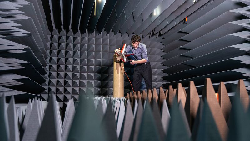 Electrical engineering graduate student Jacdon Del Green in the anechoic chamber, adjusting a standard gain antenna used to calibrate the measurement. | Image: Texas A&M Engineering
