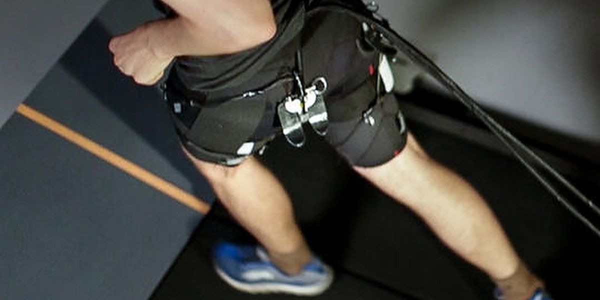 Researchers have demonstrated a tethered soft exosuit that can reduce the metabolic cost of running on a treadmill by 5.4 percent compared to not wearing the exosuit (Image courtesy of The Wyss Institute)