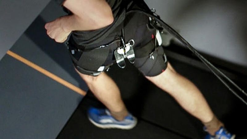 Researchers have demonstrated a tethered soft exosuit that can reduce the metabolic cost of running on a treadmill by 5.4 percent compared to not wearing the exosuit (Image courtesy of The Wyss Institute)