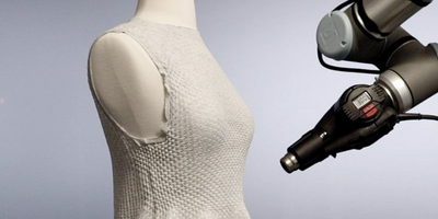 Caption:In late 2023 the MIT Self Assembly Lab and the high-tech fashion company Ministry of Supply debuted their 4D Knit Dress at the latter's store Boston, complete with a robotic arm working its way around a dress as customers watched. Credits:Image courtesy of MIT Self Assembly Lab