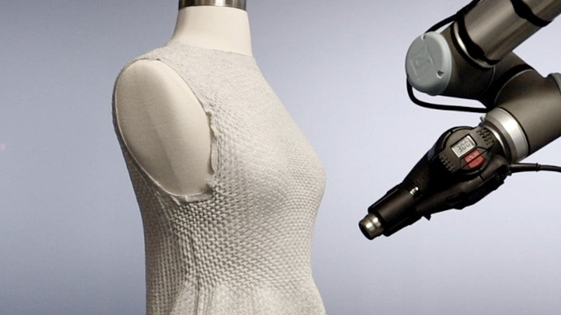 Caption:In late 2023 the MIT Self Assembly Lab and the high-tech fashion company Ministry of Supply debuted their 4D Knit Dress at the latter's store Boston, complete with a robotic arm working its way around a dress as customers watched. Credits:Image courtesy of MIT Self Assembly Lab