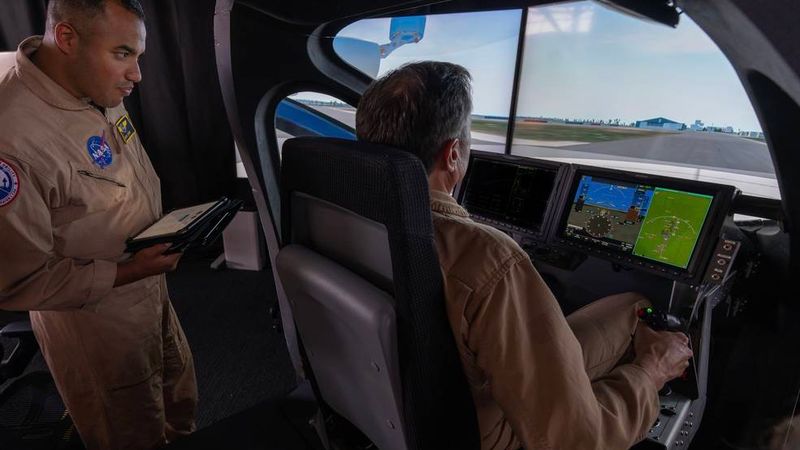 NASA research pilots David Zahn, left, and Wayne Ringleberg at the controls of Joby Aviation's S4 simulator entering and testing flight path data to develop navigation codes. Credits: Joby Aviation