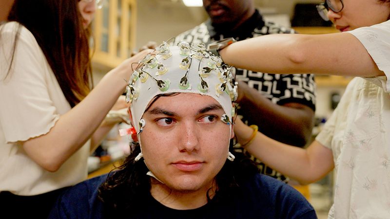 As part of a study of stress and the brain, researchers monitor electrical signals on a participant’s scalp using a swim cap studded with electrodes. Photo by Virgil Ward