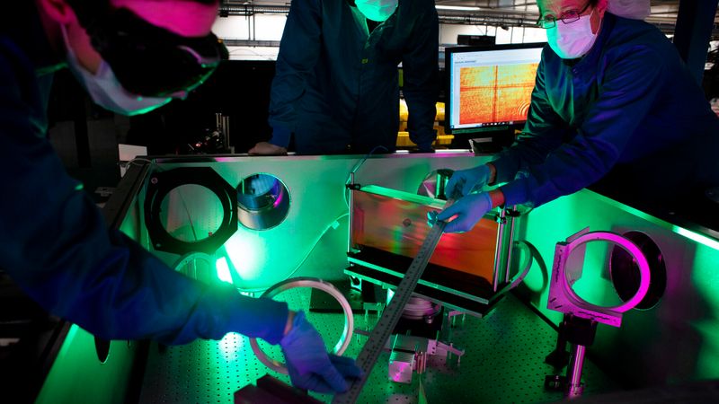 Laser engineer Lauren Weinberg, research scientist John Nees and research engineer Galina Kalinchenko working on the ZEUS laser. Photo: Marcin Szczepanski/Michigan Engineering