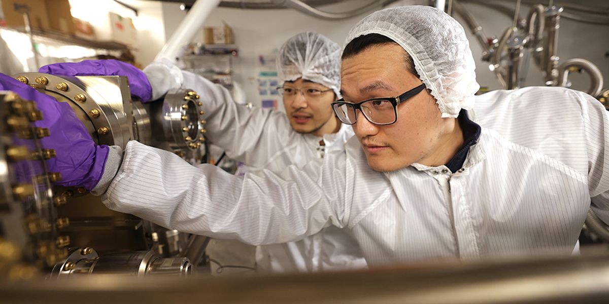 Yuanpeng Wu, right, a postdoctoral research fellow, and Yixin Xiao, a PhD student, both in ECE, and members of Professor Zetian Mi’s research group, working in the molecular beam epitaxy lab in the EECS Building on the North Campus of the University of Michigan. In the lab they are growing Indium gallium nitride (InGaN) nanowire micro-LEDs using molecular beam epitaxy. Photo: Brenda Ahearn/College of Engineering