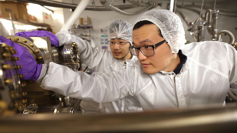 Yuanpeng Wu, right, a postdoctoral research fellow, and Yixin Xiao, a PhD student, both in ECE, and members of Professor Zetian Mi’s research group, working in the molecular beam epitaxy lab in the EECS Building on the North Campus of the University of Michigan. In the lab they are growing Indium gallium nitride (InGaN) nanowire micro-LEDs using molecular beam epitaxy. Photo: Brenda Ahearn/College of Engineering