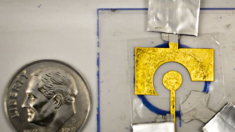 The electrochemical sensors developed in Ariel Furst’s lab consist of DNA adhered to an inexpensive gold leaf electrode, which is laminated onto a sheet of plastic. Credit: Courtesy of the researchers; edited by MIT News