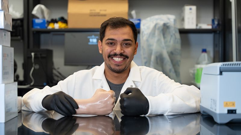 Graduate student Majed Othman Althumayri demonstrates an Ecoflex cast of his hand. | Image: Emily Oswald/Texas A&M Engineering