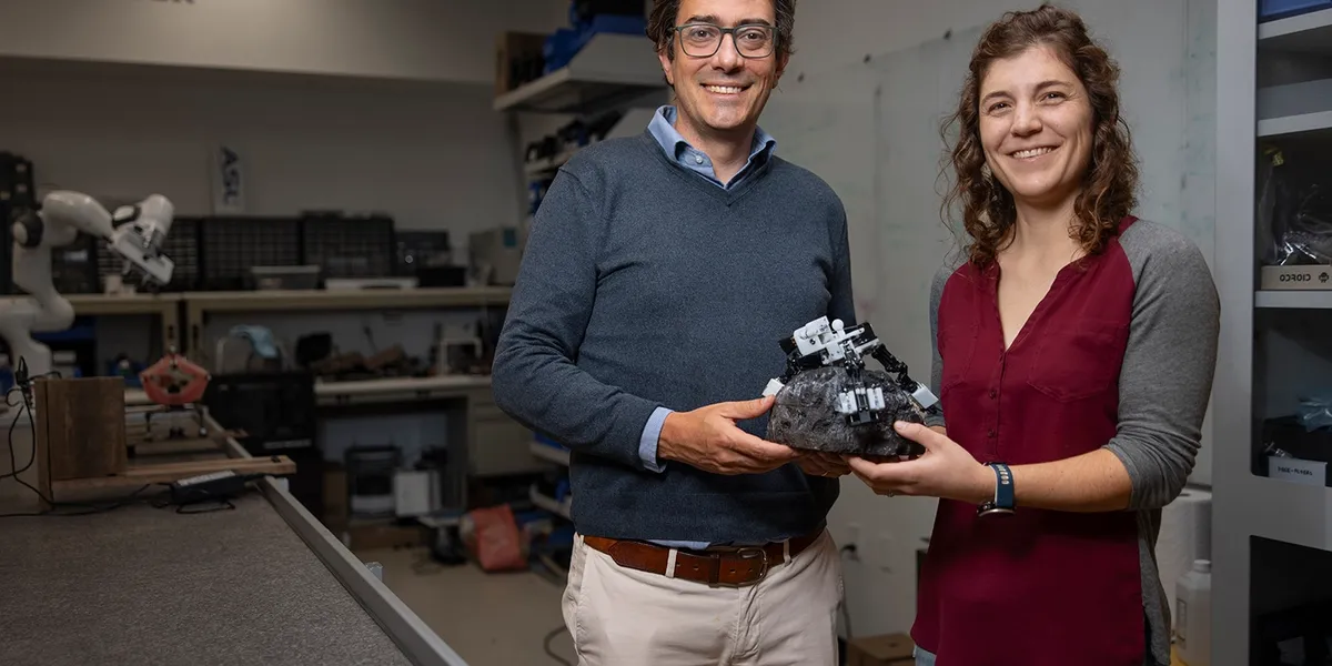 Associate Professor Marco Pavone and PhD student Stephanie Newdick holding their ReachBot prototype. | Photo courtesy of Andrew Brodhead