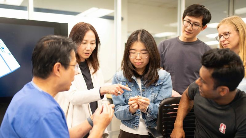 Professors Zhenan Bao and Xiang Qian in the Ideation and Prototyping Lab (IPL) with students Shiyuan Wei, Kuang Jung Hsu, Ines Weber, and Alam Mahmud. Wei is holding tiny electrochemical probes that could eventually be used for neurotransmitter detection. | Yilei Wu