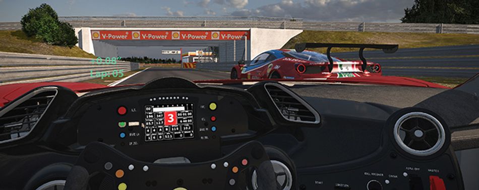 View looking from inside a Ferrari race car onto the track. A red car is to the right. The steering wheel and dash are seen in the bottom half of the image.