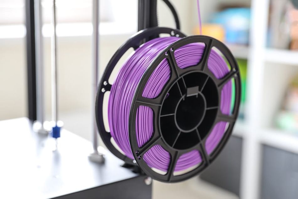 Purple filament spool on 3D printer