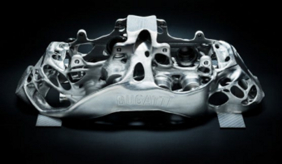 Photograph of the metal brake caliper component, produced by Bugatti for their Chiron.