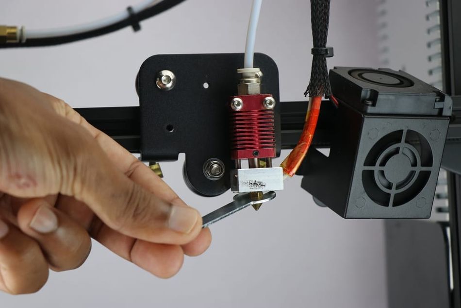 Hand and wrench with 3D printer nozzle