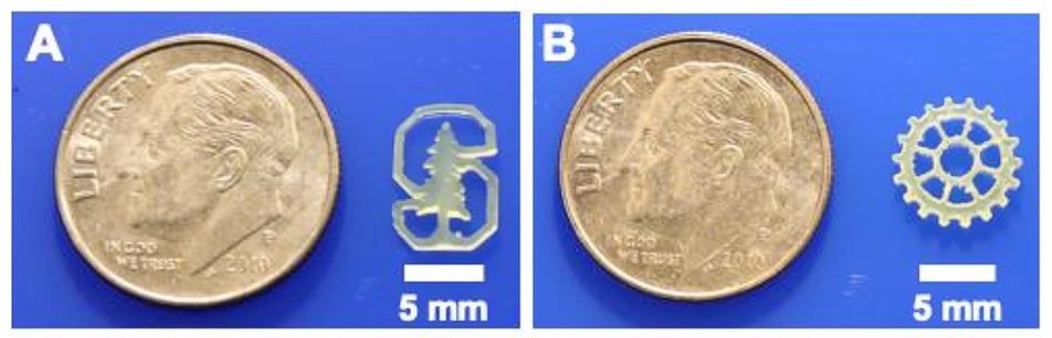 Two photographs of an American quarter with 3D-printed objects next to it, both approximately 5mm wide: a Stanford University logo and a gear. Both show high detail levels and smooth surfaces.