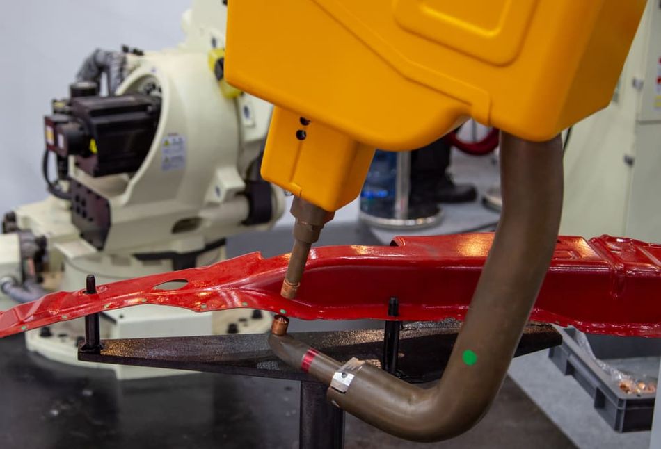 Robotic arm doing spot welding in automotive industry