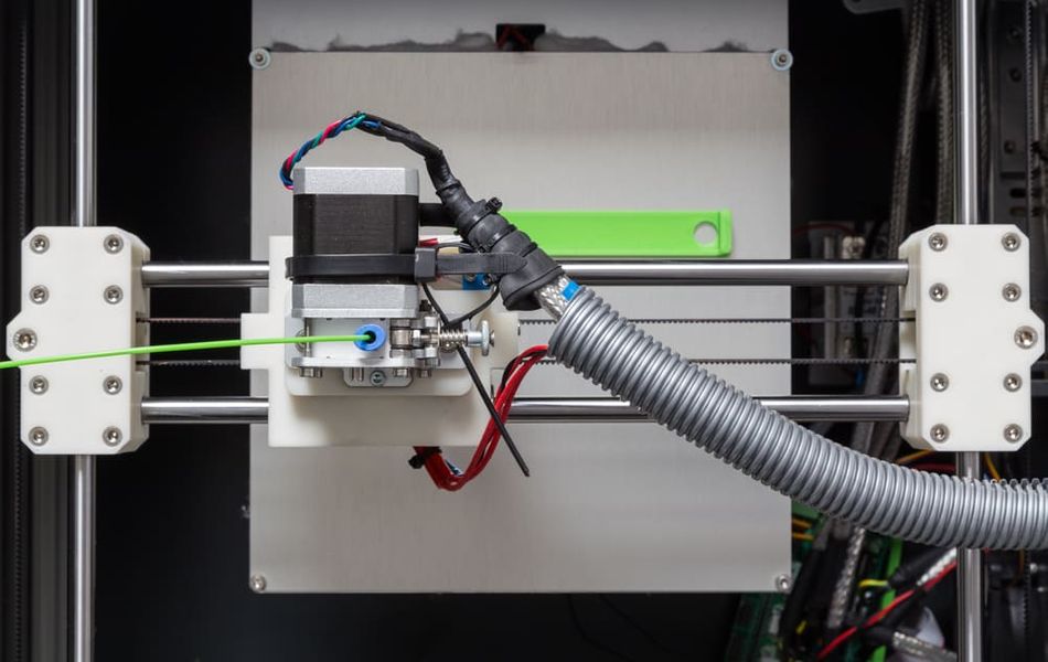 3D printer from above with green filament