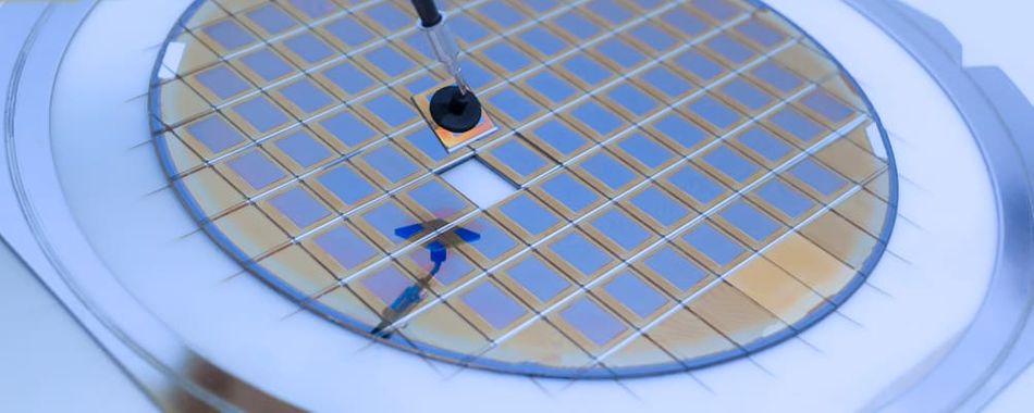 Silicon wafer with microchips fixed in a holder with a steel frame after the dicing process and separate microchips.