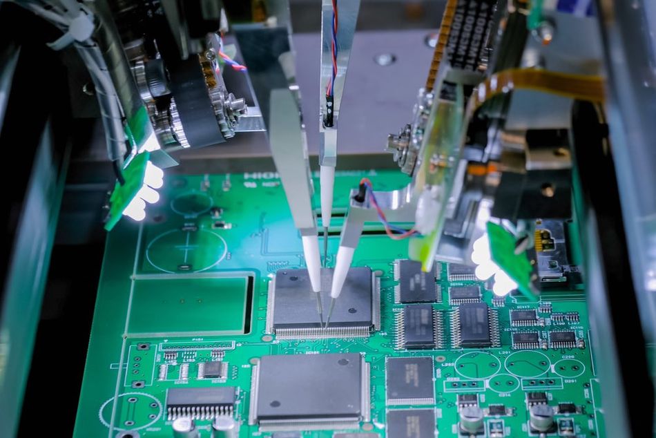 Flying Probes testing a PCB featuring various electronic components 