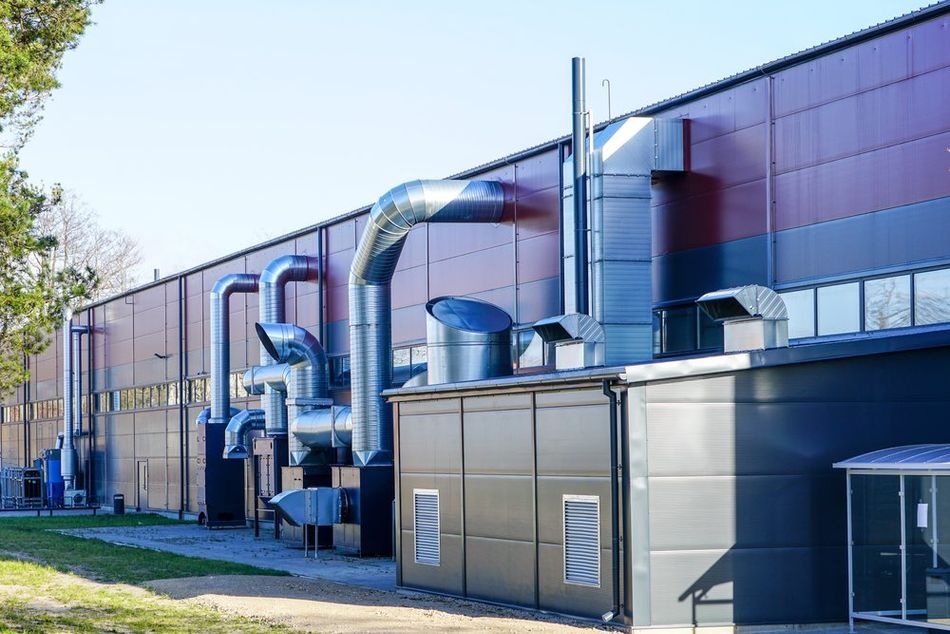 View of a stainless steel heating and ventilation system in a factory setup