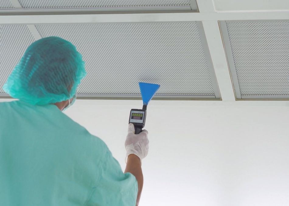 A technician scanning a cleanroom HEPA filter